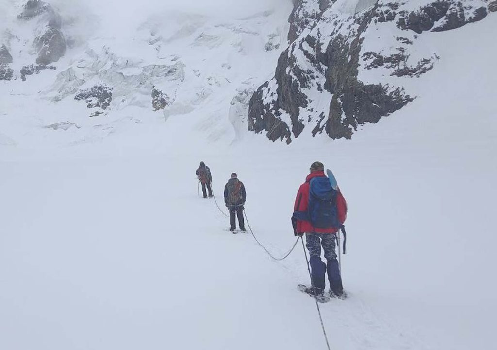 3 glaciologists followed and approached the glacier. This is their regular job. Despite their low wages, they work in such dangerous jobs to support their families. Because they love this job. Kyrgyz Republic, Issyk-Kul region, Jeti-Oguz district. Photo taken on Redmi Note 9.