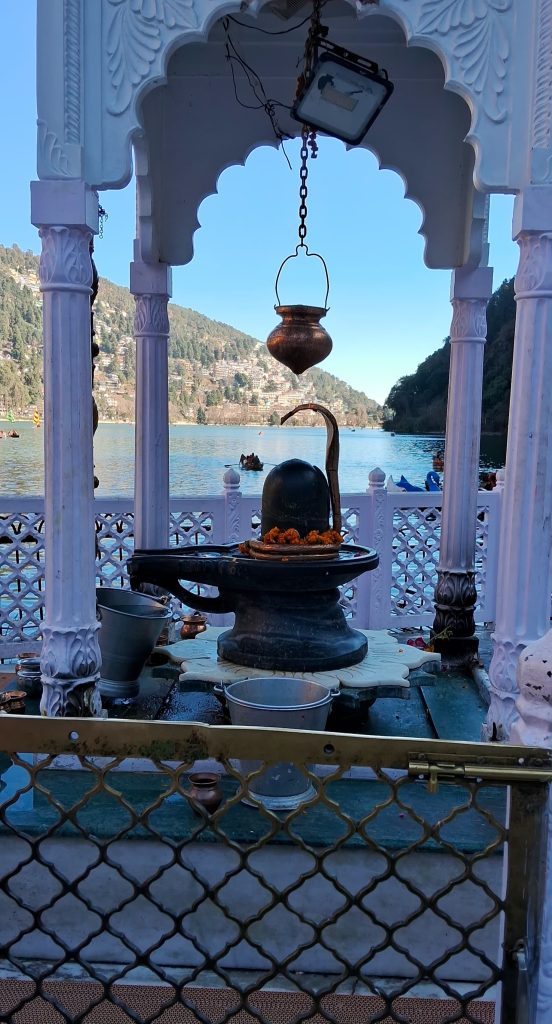 “Divine Serenity: The Sacred Shiva Lingam by the Lake” (A spiritual and peaceful setting with a Shivling overlooking the calm waters.)